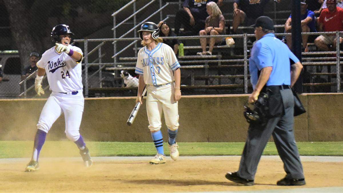 Livingston High School’s Isaac Macias (24) scores the game-winning run in the bottom of the ninth inning as El Capitan High School’s Jarrett Blake looks on during the County Clash All-Star Game at Merced College on Saturday, June 17, 2023.