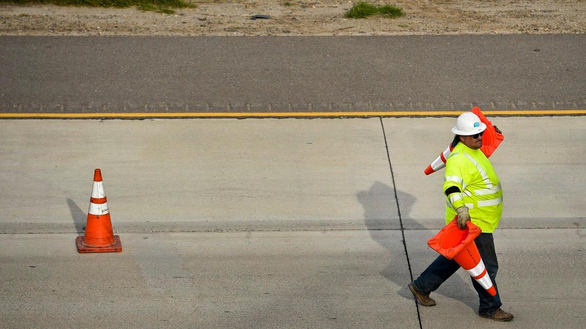 A California Department of Transportation employee places traffic cones along southbound Highway 99 following a semi-truck crash in Merced, Calif., Thursday, Jan. 8, 2015. Caltrans has announced it has completed a $4.7 million project along State Route 152 and Interstate 5 in Merced County.
