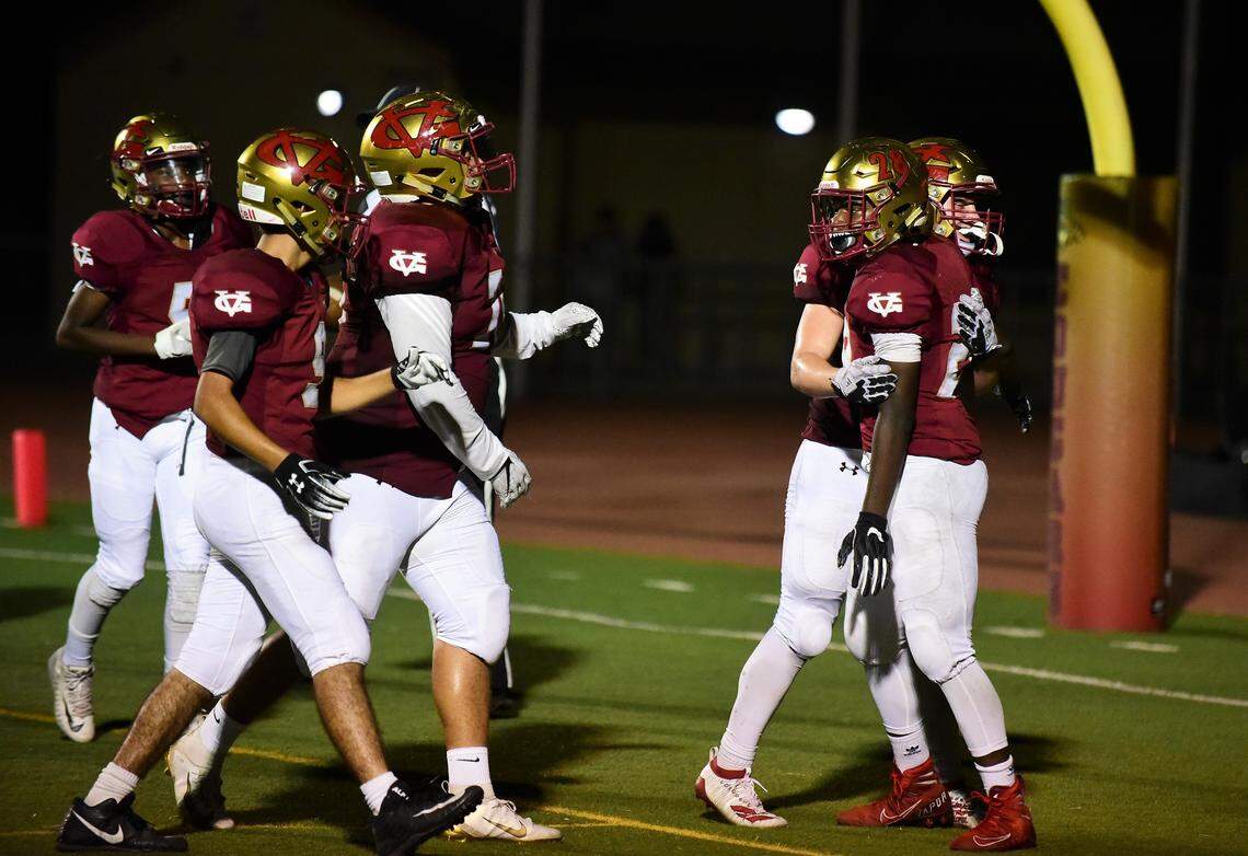 Golden Valley sophomore Jabari Phillips is congratulated by teammate Joshua Hickman and other teammates after Phillips scored his sixth touchdown in a 49-12 win over Livingston on Friday night at Veterans Stadium.