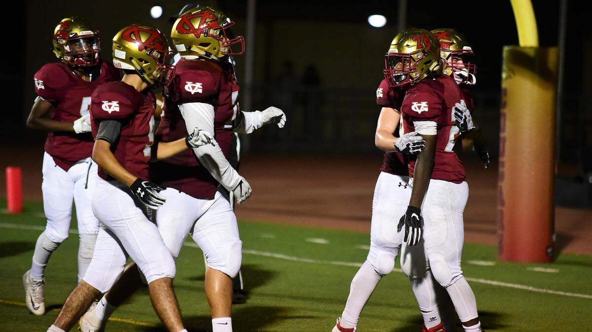 Golden Valley sophomore Jabari Phillips is congratulated by teammate Joshua Hickman and other teammates after Phillips scored his sixth touchdown in a 49-12 win over Livingston on Friday night at Veterans Stadium.