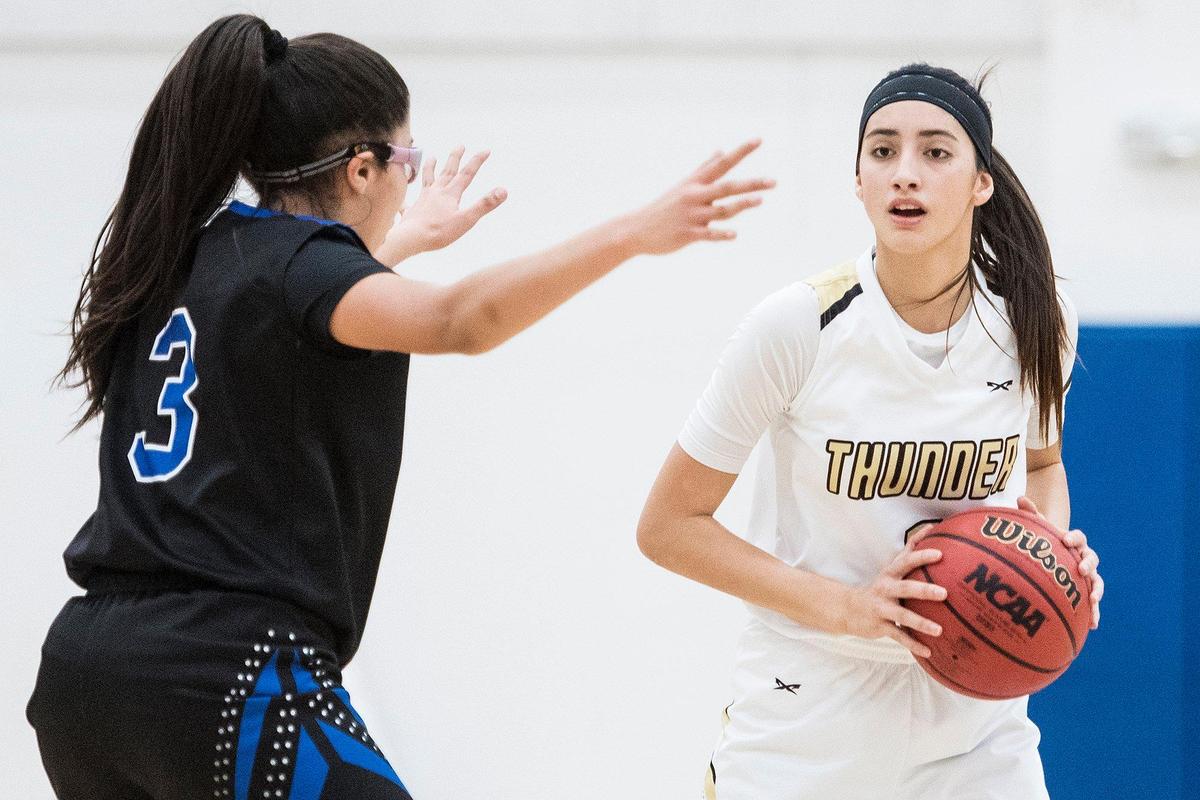 Buhach Colony junior Caly Curran (1) is guarded by Atwater senior Marisa Martinez (3) during a game at Atwater High School in Atwater, Calif., on Thursday, Jan. 17, 2019.