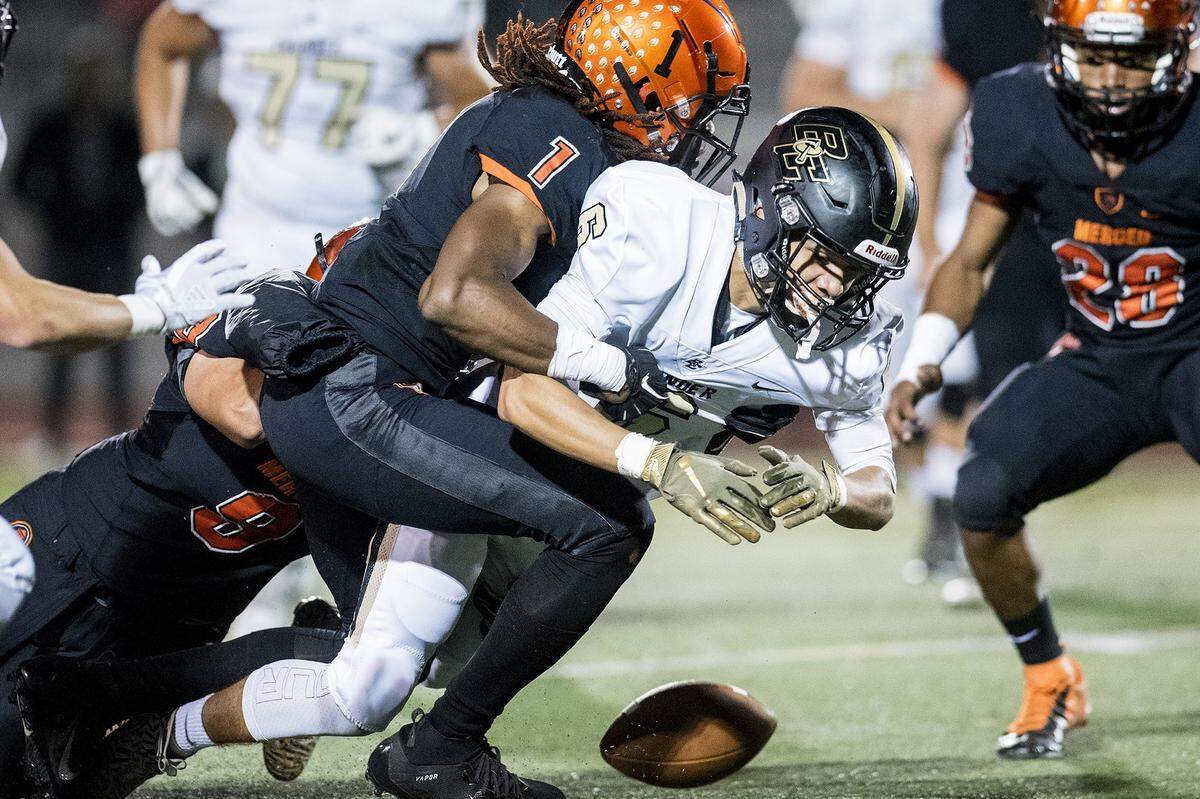 Buhach Colony junior Oscar Smallwood (6) fumbles the ball as he is hit by Merced senior Dhameer Warren (1) during a game at Veterans Stadium in Merced, Calif., on Friday, Oct. 5, 2018. The Bears beat the Thunder 55-14.