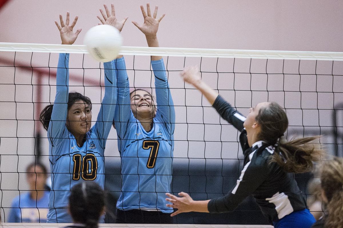 El Capitan juniors Allyson Saelee (10) and Yatzary Lua (7) attempt to block an Atwater spike during a match at El Capitan High School in Merced, Calif., on Wednesday, Aug. 29, 2018. The Gauchos beat the Falcons 3-0.