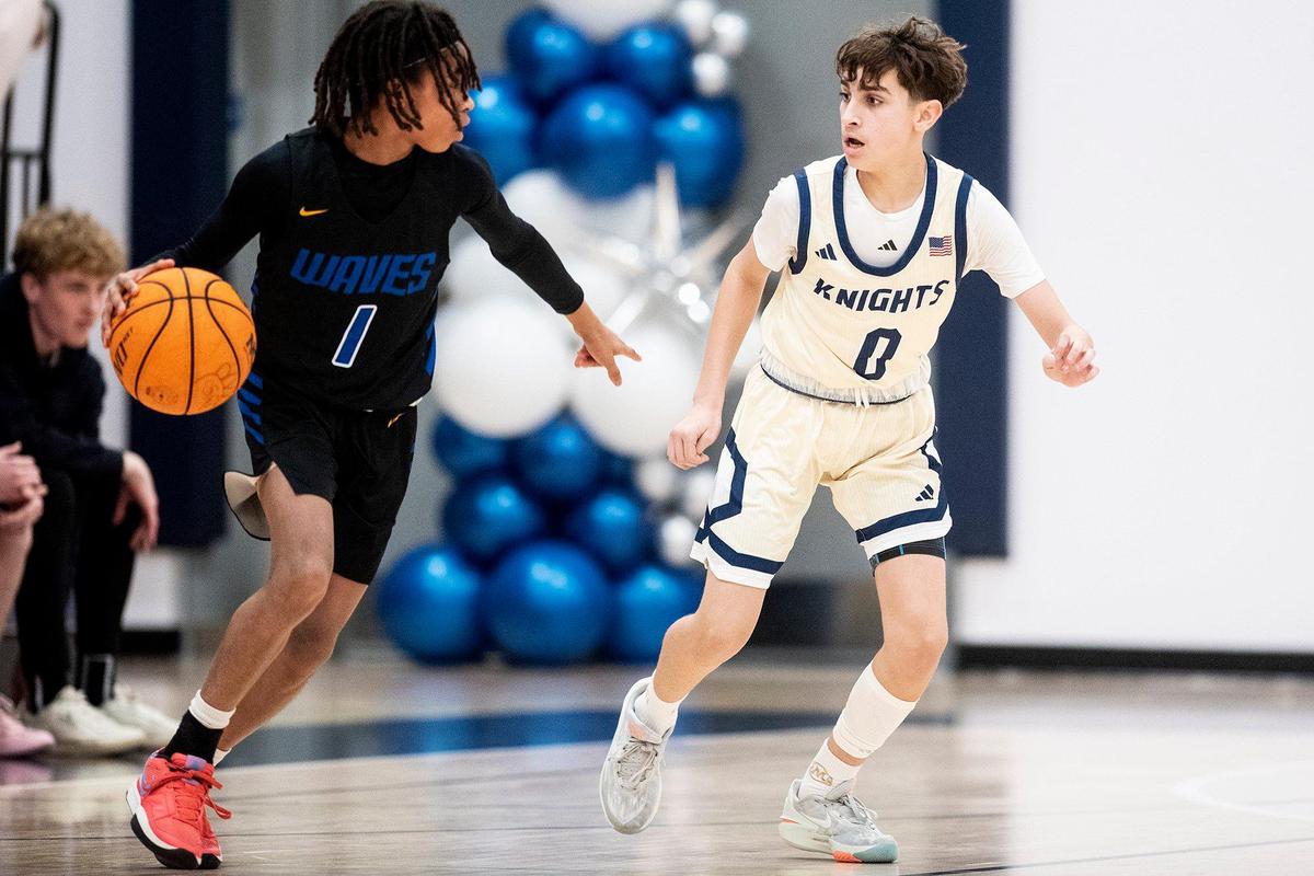 Stone Ridge Christian freshman Marcus Parker (0) guards Sacramento Waldorf junior Jayden Palmer-Anthony (1) during a CIF Sac-Joaquin Section Division 6 playoff game at Stone Ridge Christian High School in Merced, Calif., on Tuesday, Feb. 20, 2024. The Knights beat the Wave 50-37.