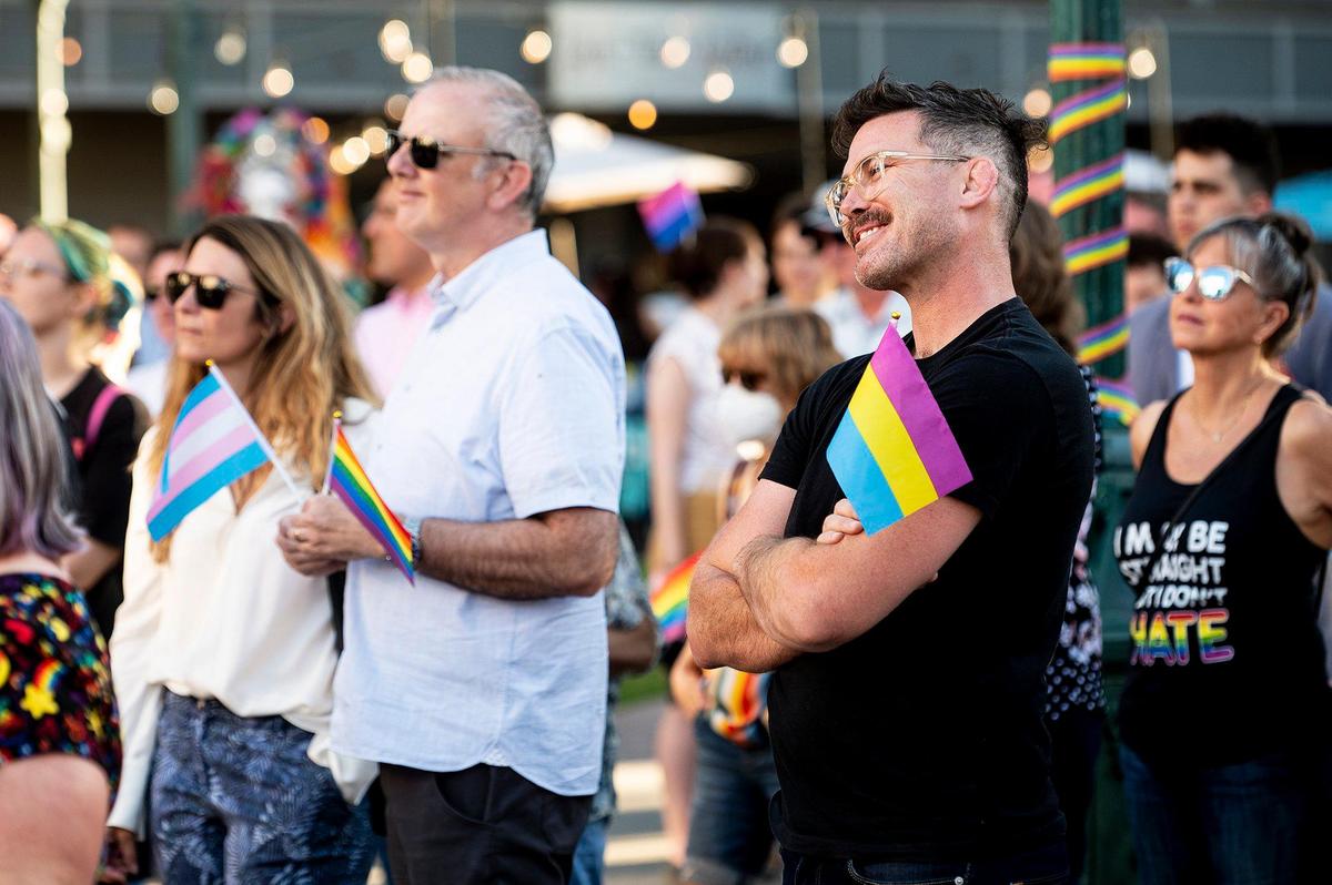 Members of the community look on during the Pride Progress flag raising ceremony at Bob Hart Square in Merced, Calif., on Wednesday, June 1, 2022. The Merced City Council approved the addition of the Pride flag to the regular flag calendar, meaning the flag will fly over Bob Hart Square annually during the month of June.