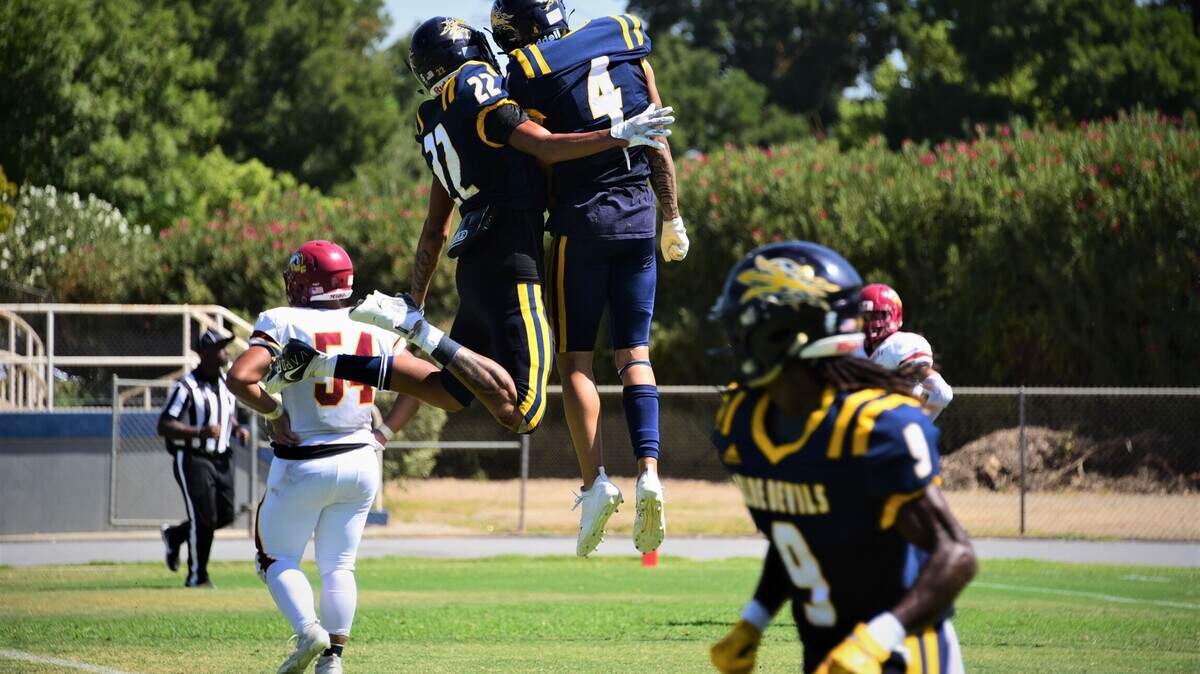 Merced College receiver Ezra Morales (4) celebrates after scoring a touchdown with teammate DaSani Tate (22) during a game against Los Medanos on Saturday, Sept. 11, 2021 at Don Odishoo Field in Merced, Calif.
