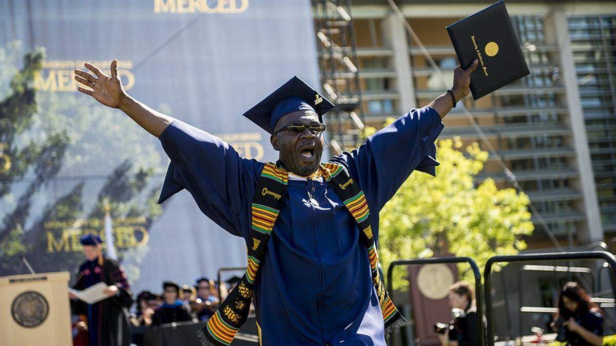 Auguste Kouadio, 50, of the Ivory Coast, celebrates after graduating with his master’s degree in interdisciplinary humanities during the University of California, Merced School of Social Sciences, Humanities and Arts spring commencement in the Carol Tomlinson-Keasey Quad on the UC Merced campus in Merced, Calif., on Saturday, May 12, 2018.