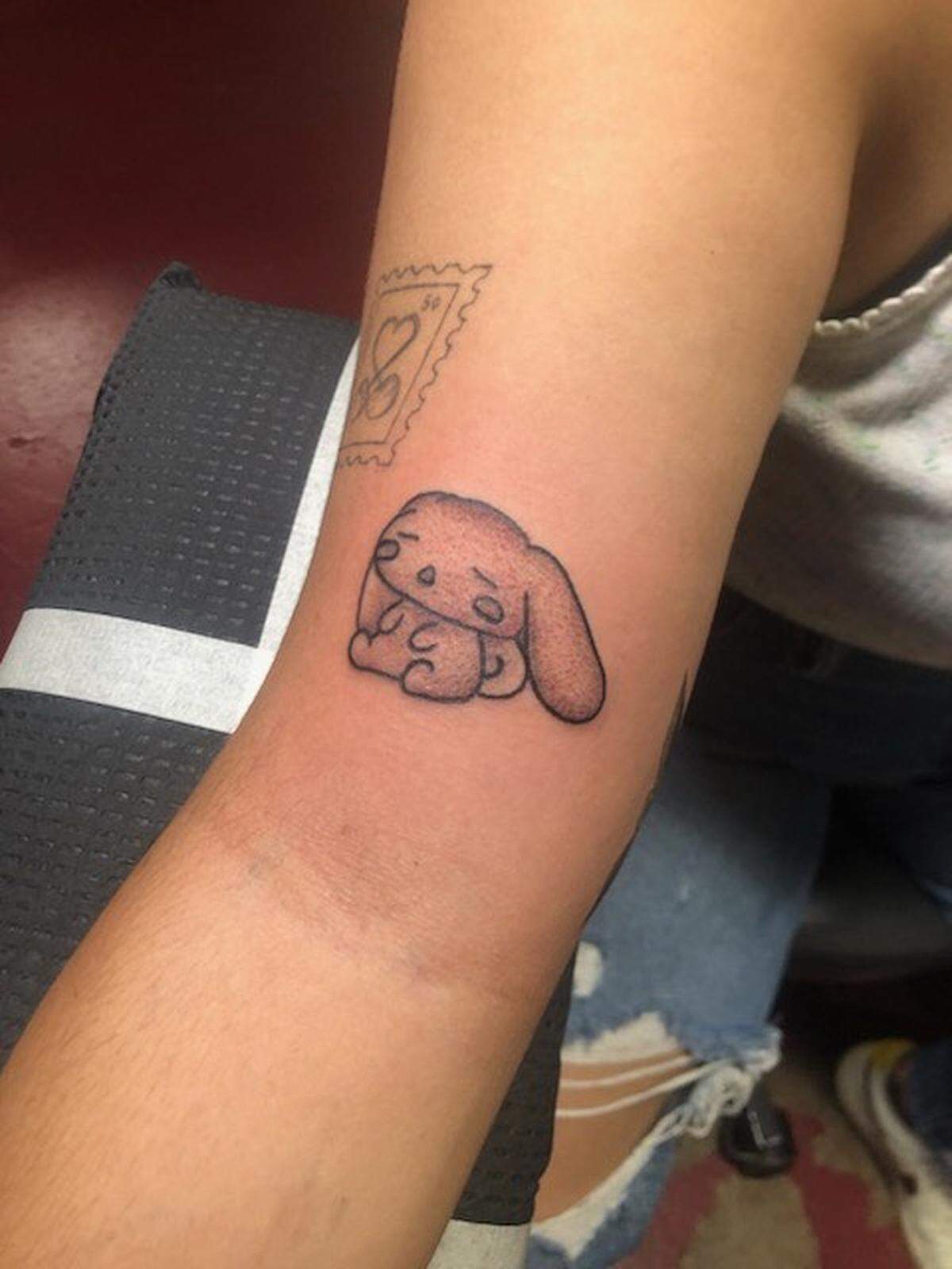 Tattoo of Sanrio character, Cinnamoroll, on client’s bicep by Main Street Tattoo and Body Piercing artist, @rafatatuajes1989. Cinnamoroll was a popular choice at the shop, the artists said. Courtesy of @rafatatuajes1989.