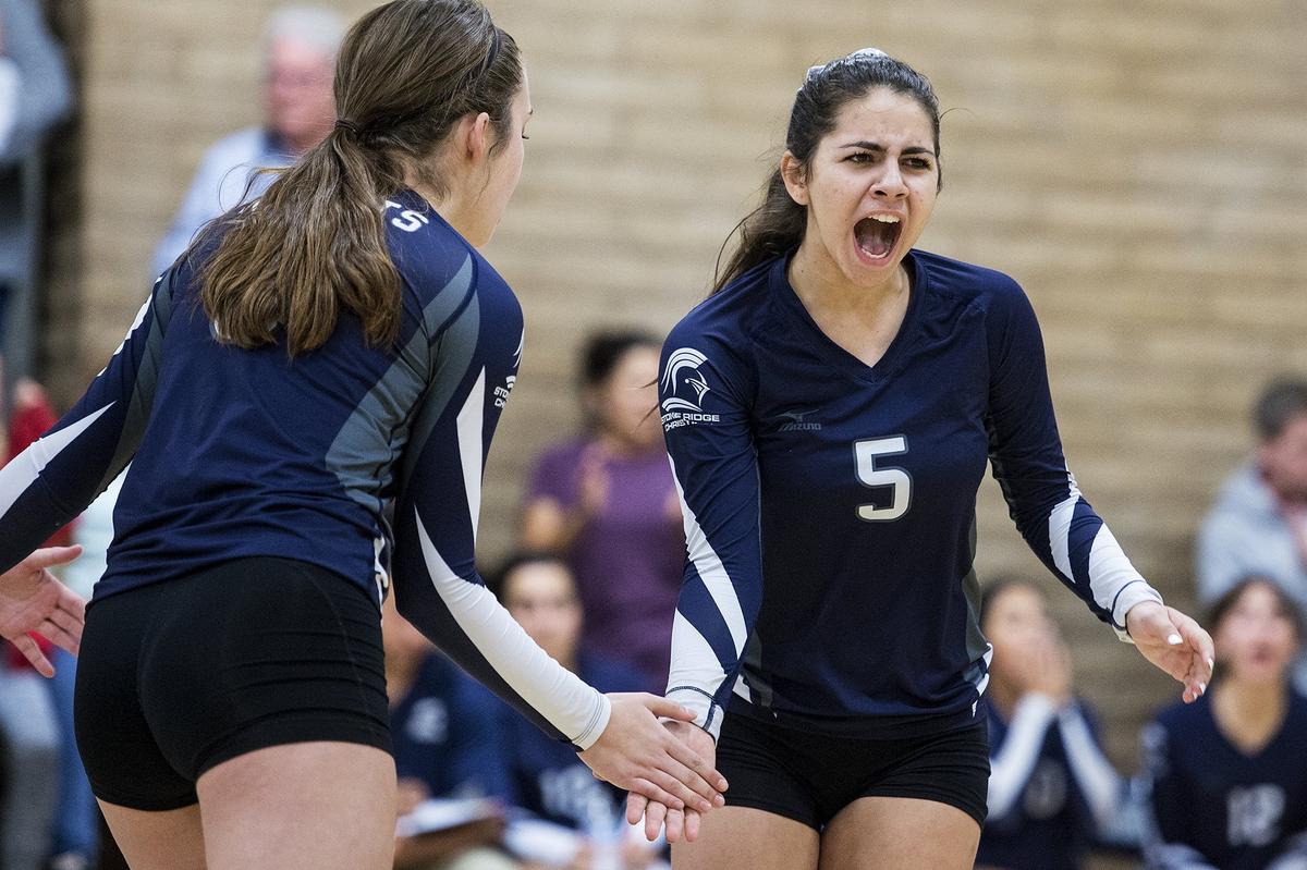 Stone Ridge Christian junior Brooke Wareham (5) celebrates a Knights point with teammates during a match against Forest Lake Christian in the CIF NorCal Division VI Regional Championship at First Baptists Merced in Merced, Calif., on Tuesday, Nov. 13, 2018. The Knights beat the Falcons 3-0.