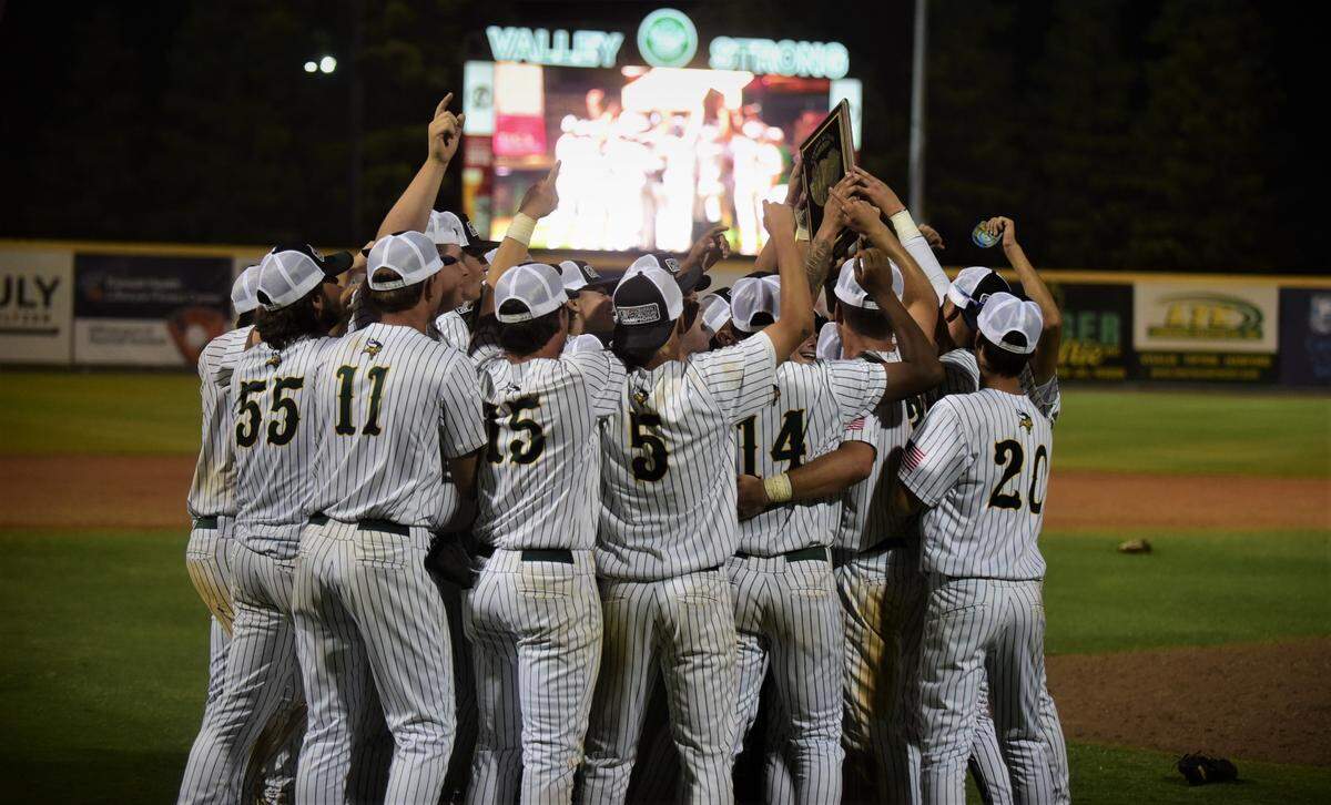 The Kingsburg High School players hoist up the championship plaque after winning the Central Section Division III Valley Championship with a 7-5 victory over Dos Palos on Thursday night at Valley Strong Ballpark in Visalia, Calif.