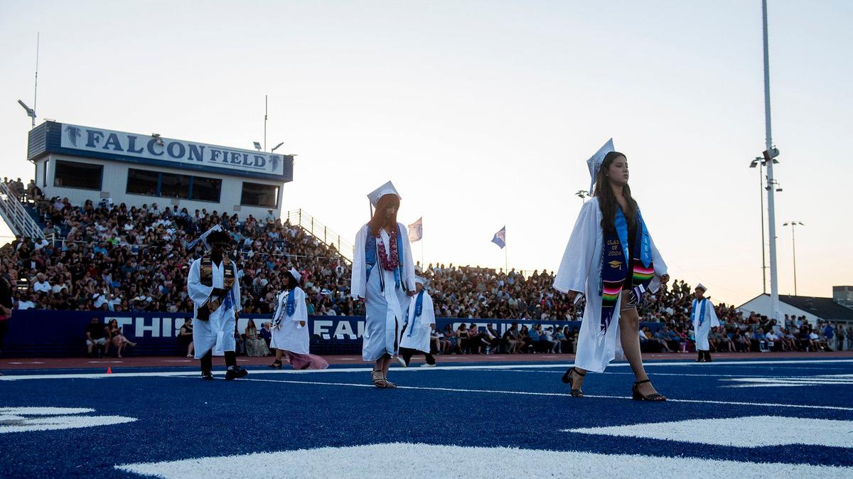 Graduates walk to their seats during the Atwater High School class of 2024 commencement ceremony at Atwater High School.