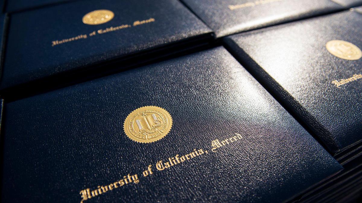 Degrees containing the seal of the University of California, sit on a table prior to a commencement ceremony for the University of California, Merced School of Engineering and School of Natural Sciences in the Carol Tomlinson-Keasey Quad on the UC Merced campus in Merced, Calif., on Saturday, May 13, 2017.