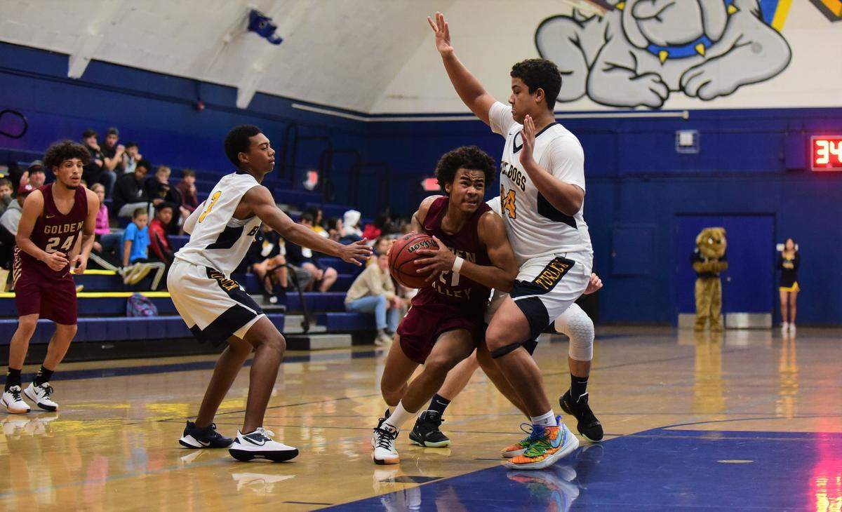 Golden Valley senior Avery Townsel attempts to drive past Turlock center Solomon Ussery during the Cougars’ 52-36 win over the Bulldogs in the Godinez Tournament championship game on Friday, Dec. 14, 2019.