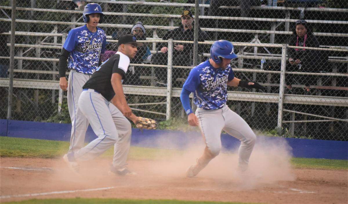 Atwater High senior Bo Valladao scores on a wild pitch ahead of the tag of Mountain House pitcher Jareth Franco during the third inning of a game on Tuesday, April 19, 2022 at Memorial Ballpark in Atwater, Calif.