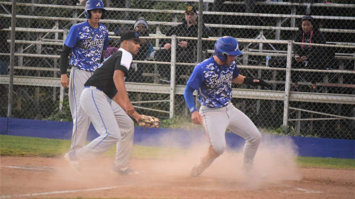 Atwater High senior Bo Valladao scores on a wild pitch ahead of the tag of Mountain House pitcher Jareth Franco during the third inning of a game on Tuesday, April 19, 2022 at Memorial Ballpark in Atwater, Calif.
