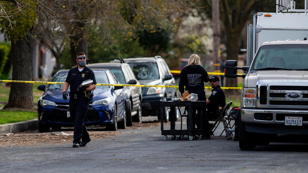 The Merced Police Department investigates the scene of a shooting that killed a 14-year-old male in the 1100 block of P Street in Merced, Calif., on Monday, March 8, 2021.