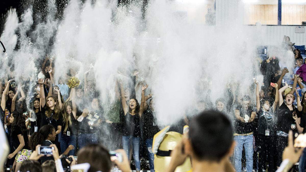 The Buhach Colony High School student section throws powder into the air during a game against Pacheco at Atwater High School in Atwater, Calif., Friday, Sept. 16, 2016.