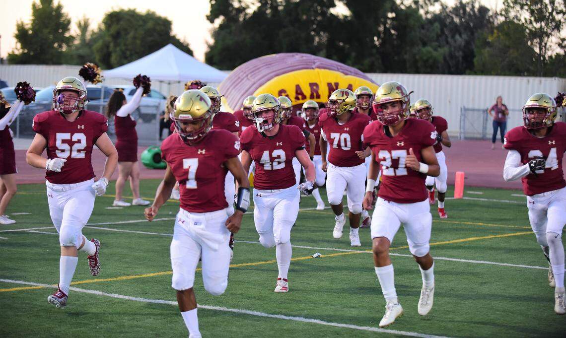 The Golden Valley High football team takes the field prior to Friday night’s game against Livingston. The Cougars won 49-12.