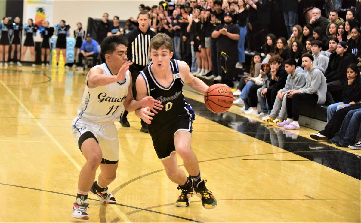 Atwater High senior Colton Dukes (0) tries to drive to the basket against El Capitan’s Angelo Tumonong (11) during a game on Friday, Jan. 13, 2023 at El Capitan High School.