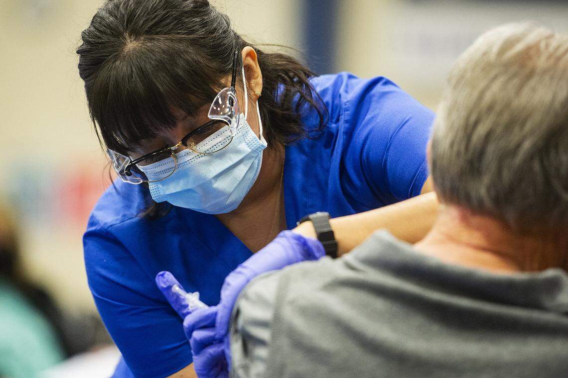 Merced College nursing student Kimberly Zotea administers a COVID-19 vaccine to a patient at a vaccination clinic inside a Merced College gymnasium in Merced, Calif., on Wednesday, Feb. 17, 2021. Zotea said her experience in the program along with schooling and training has been a lot different than she thought it would be before she signed up. “We’re obviously have condensed to be safe. We’re having Zoom classes, we’re trying to keep a minimum of students if we do have lab or you know, we’re only allowed in certain floors for clinicals,” she said. “It’s definitely changed a lot of stuff but I’m just grateful that we even have the opportunity to still go to school and kind of have to be flexible in the process but I’m just happy that we can still do it.”