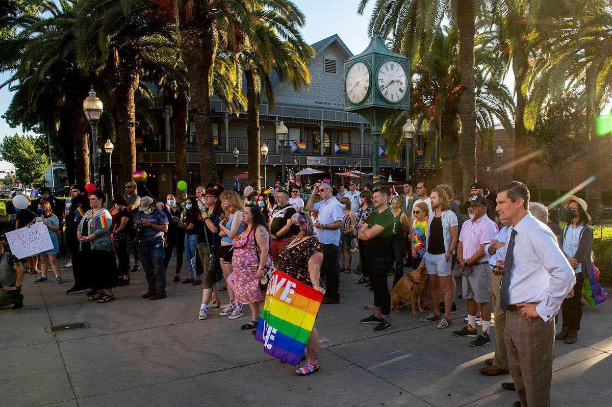 Members of the community look on during the Pride Progress flag raising ceremony at Bob Hart Square in Merced, Calif., on Wednesday, June 1, 2022. The Merced City Council approved the addition of the Pride flag to the regular flag calendar, meaning the flag will fly over Bob Hart Square annually during the month of June.