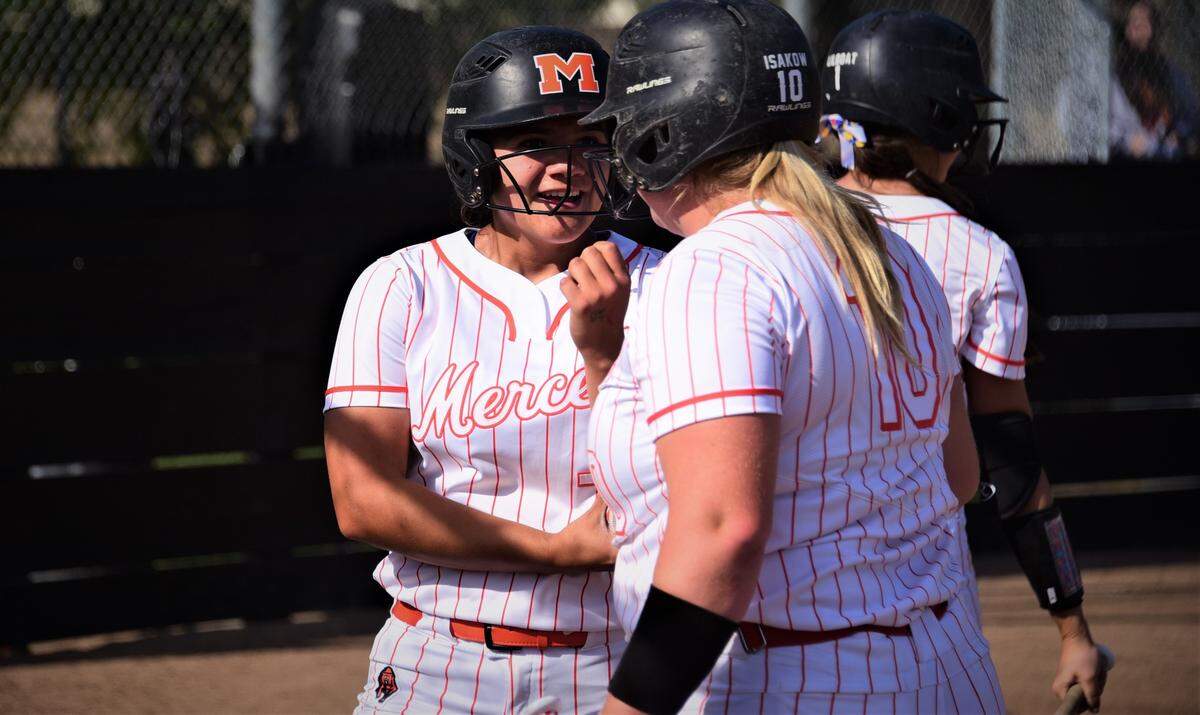 Merced High senior Ellie Alvarez (left) is congratulated after hitting a first-inning home run by teammate Hannah Isakow during a 4-3 win over Golden Valley on Thursday, March 31, 2022 at Merced High School.