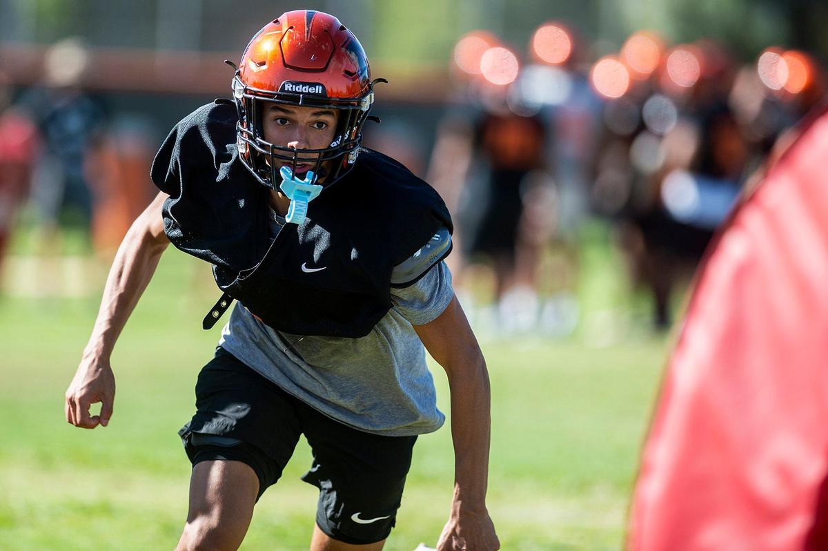 Julian Higareda runs through drills during football practice at Merced High School in Merced, Calif., on Monday, Aug. 19, 2024.