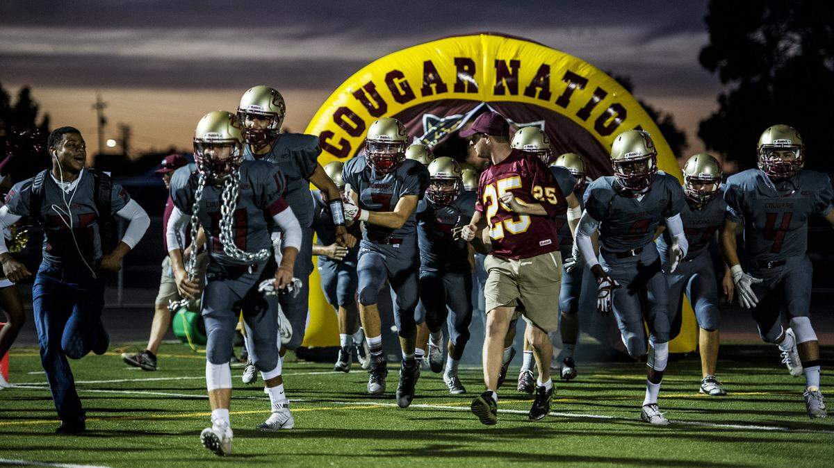 The Golden Valley Cougars take the field during a game against Chavez at Golden Valley High School in Merced, Calif., Friday, Sept. 25, 2015. The Cougars beat the Titans 30-26.