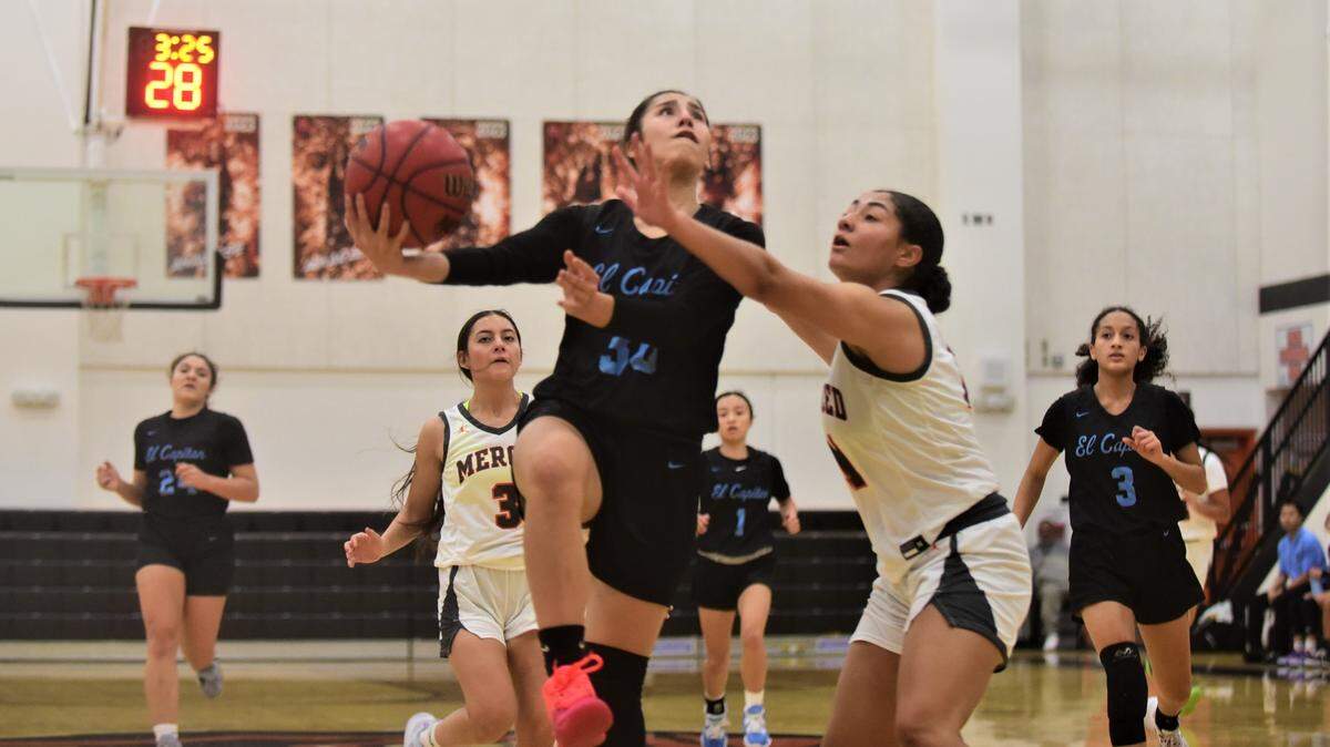El Capitan High School senior Dinah Lua (30) goes up for a layup against Merced High senior Mylah Steverson during a game on Tuesday, Jan. 3, 2022 at Merced High School.