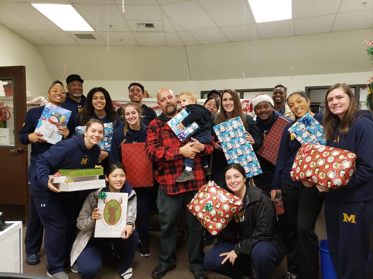 Jason Cincotta and his two sons received an abundance of gifts from the women’s basketball team on Friday morning.