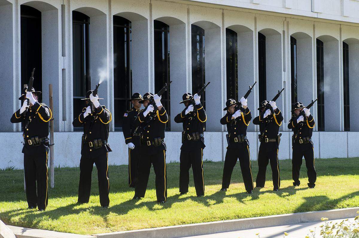 The United States Penitentiary Atwater Honor Guard performs a rifle volley during the annual Merced County Peace Officers Memorial Ceremony in Merced, Calif., on Wednesday, May 29, 2024. The ceremony honors law enforcement officers who died in the line of duty.