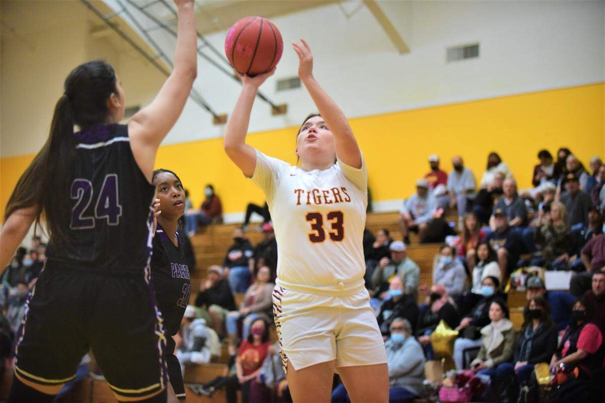 Los Banos High senior Sydney Robertson goes up for a shot against Pacheco’s Jayden Caesar during a game on Tuesday, Feb. 9, 2022 at Los Banos High School in Los Banos, Calif.