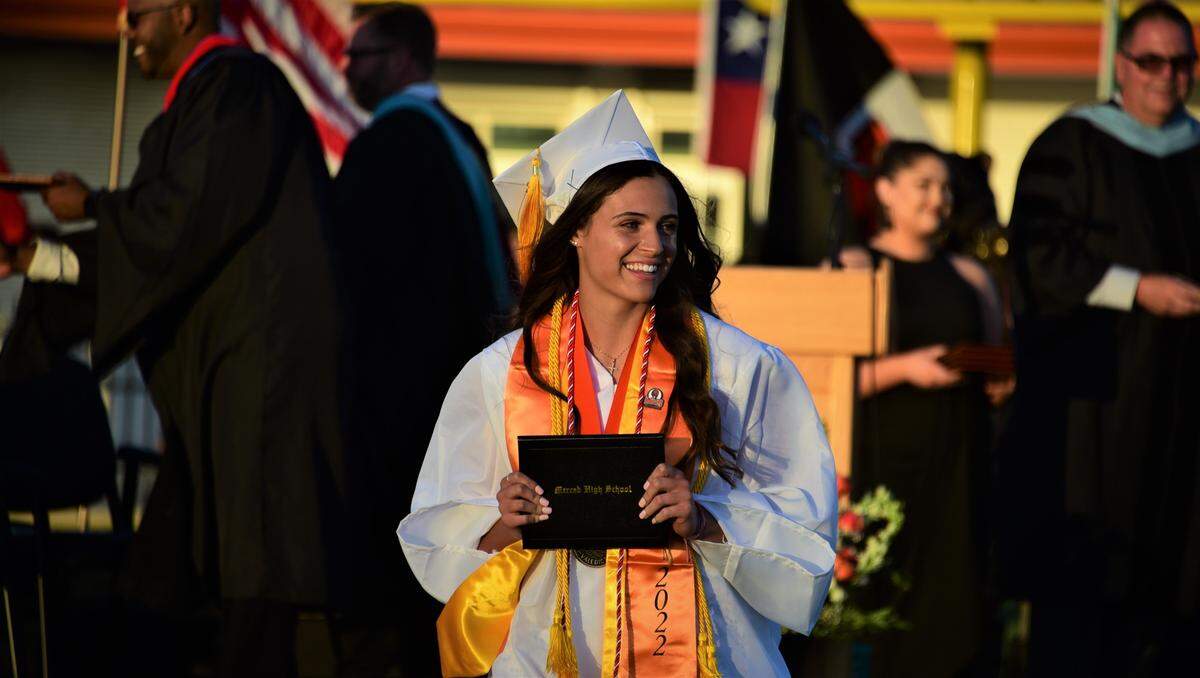 Merced High School senior Ava Brown makes her way off stage after receiving her diploma during the school’s graduation ceremony on Thursday, June 2, 2022.
