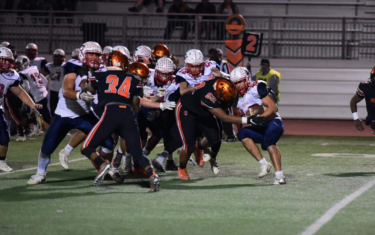 Merced High defensive lineman Jaylen Thao-Booth delivers a big hit on Beyer running back Sean Perkins during the Bears’ 20-6 playoff win over the Patriots on Friday, Nov. 8, 2019.