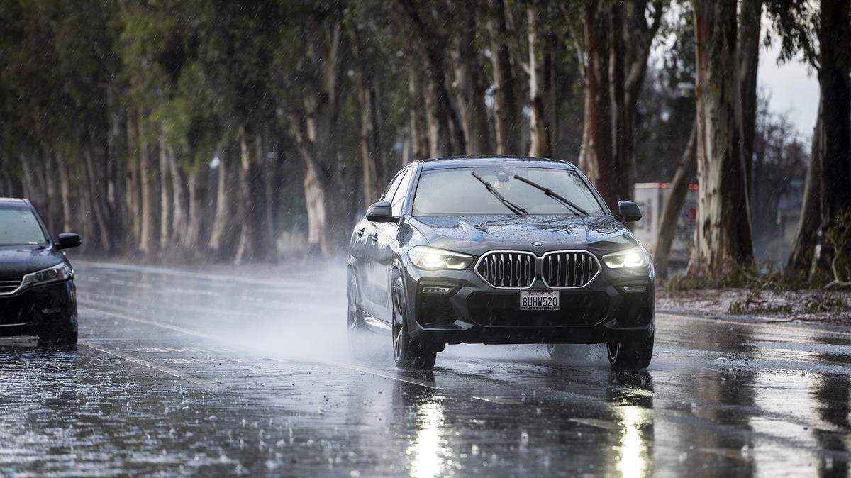 Motorists drive south along M Street during a short rain and hail storm in Merced, Calif., on Monday, Jan. 16, 2023.