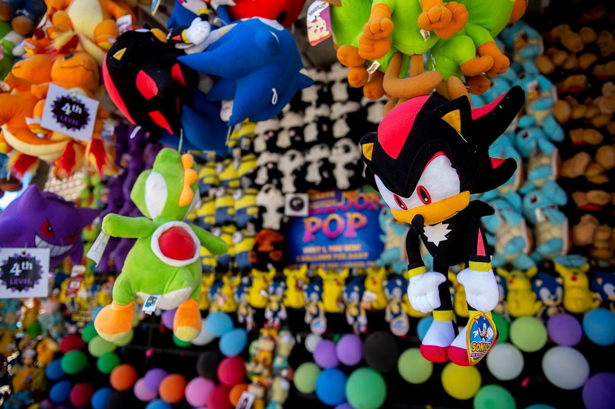 Prizes hang from the roof of a carnival game at the Merced County Fair in Merced, Calif., on Thursday, June 6, 2024.