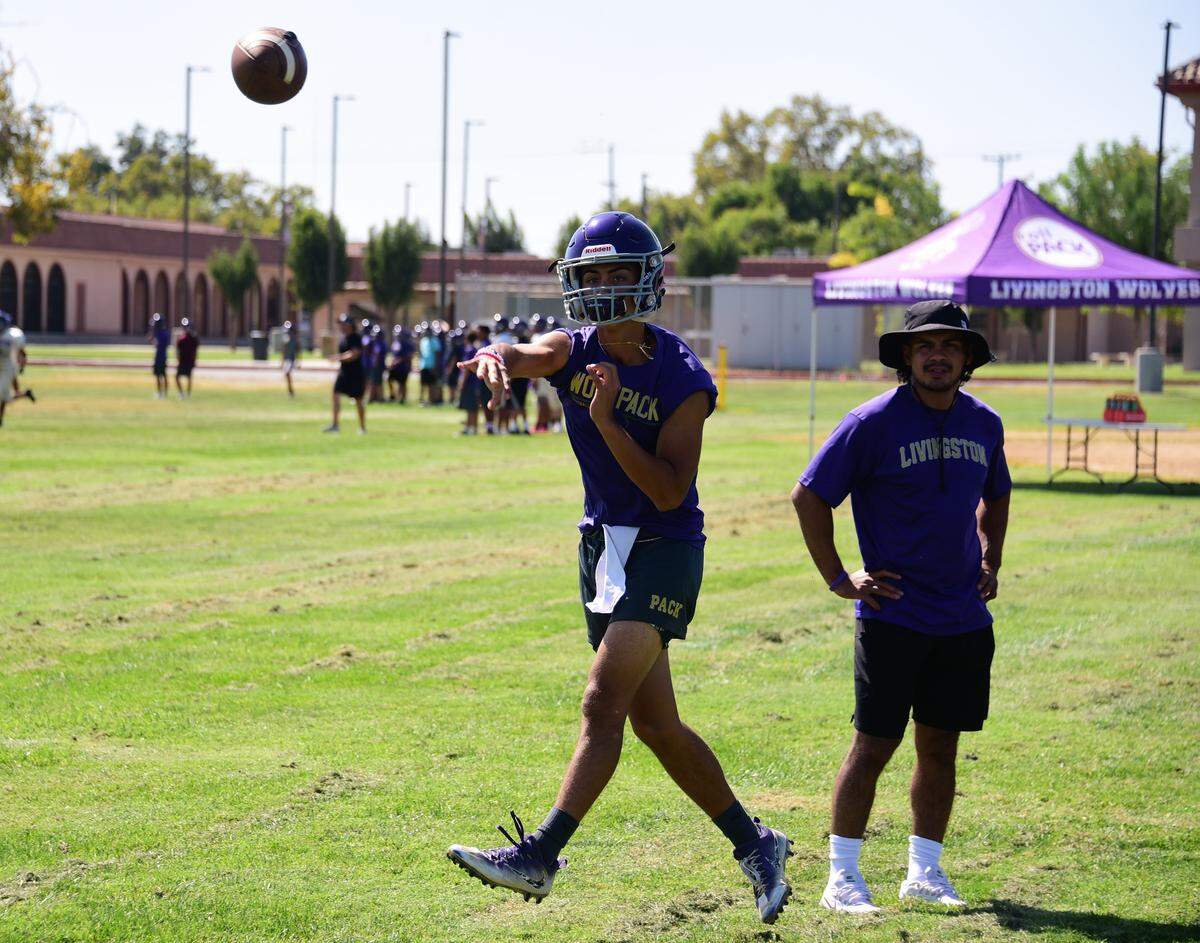 Livingston sophomore Rocklin Baptista fires a pass as assistant coach Brian Alvarez looks on during a practice on Wednesday, Sept. 11, 2019.