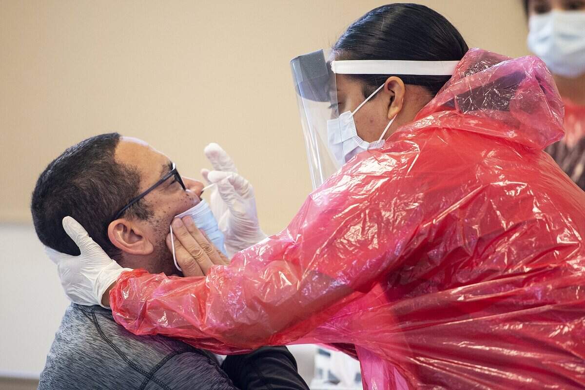 Darwin Duncan, 54, of Atwater, undergoes a test at a COVID-19 testing site located at the Merced County Fairgrounds in Merced, Calif., on Monday, May 4, 2020. According to the Merced County Department of Public Health, the new test site is thanks to a partnership with the State of California and OptumServe, a private health services company contracted by the state. The site is one of 80 locations across the state and will allow for more than 100 additional tests a day.
