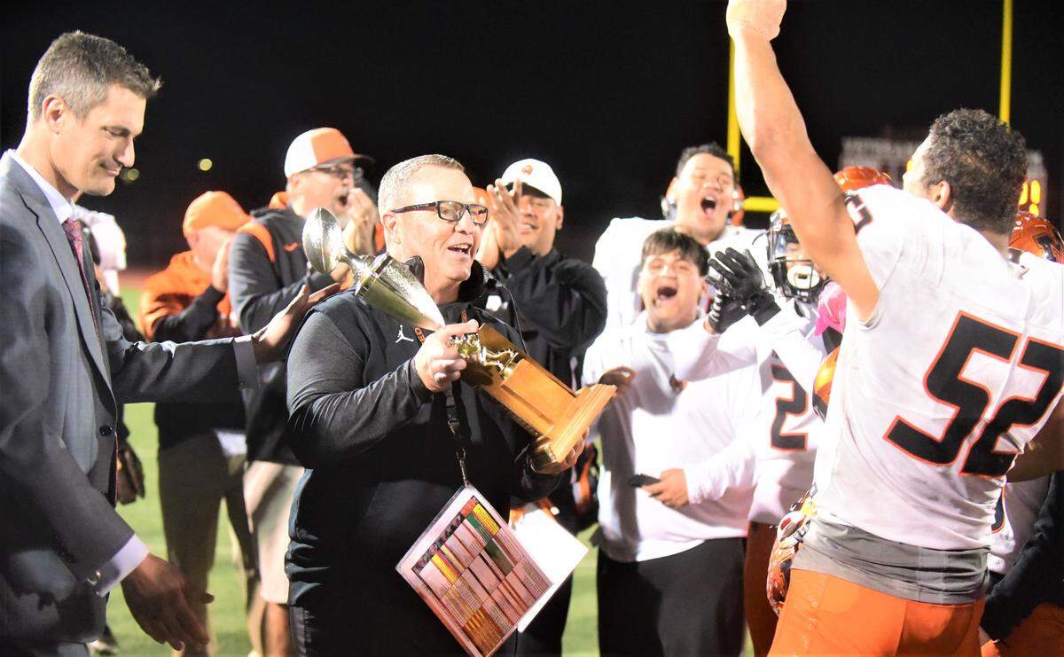 Merced Mayor Matthew Serratto presents Merced High football coach Rob Scheidt the Mayor’s Cup after the Bears defeated Golden Valley 31-6 on Friday, Oct. 28, 2022 at Veterans Stadium to extend their streak to 17 consecutive wins over the Cougars.