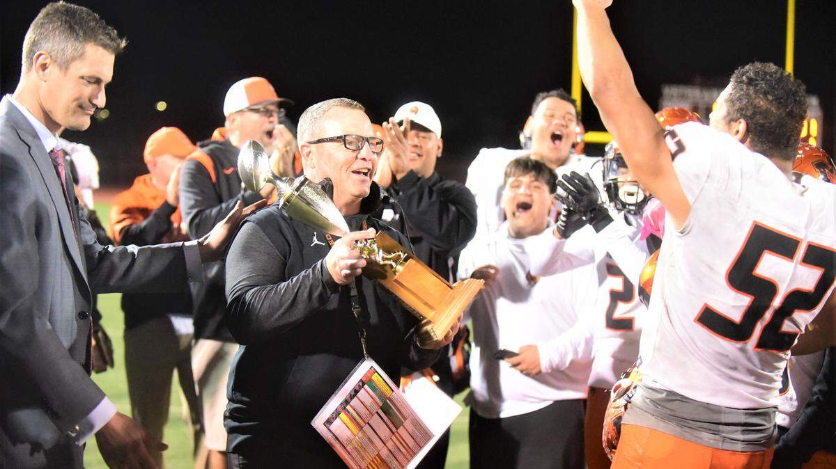 Merced Mayor Matthew Serratto presents Merced High football coach Rob Scheidt the Mayor’s Cup after the Bears defeated Golden Valley 31-6 on Friday, Oct. 28, 2022 at Veterans Stadium to extend their streak to 17 consecutive wins over the Cougars.