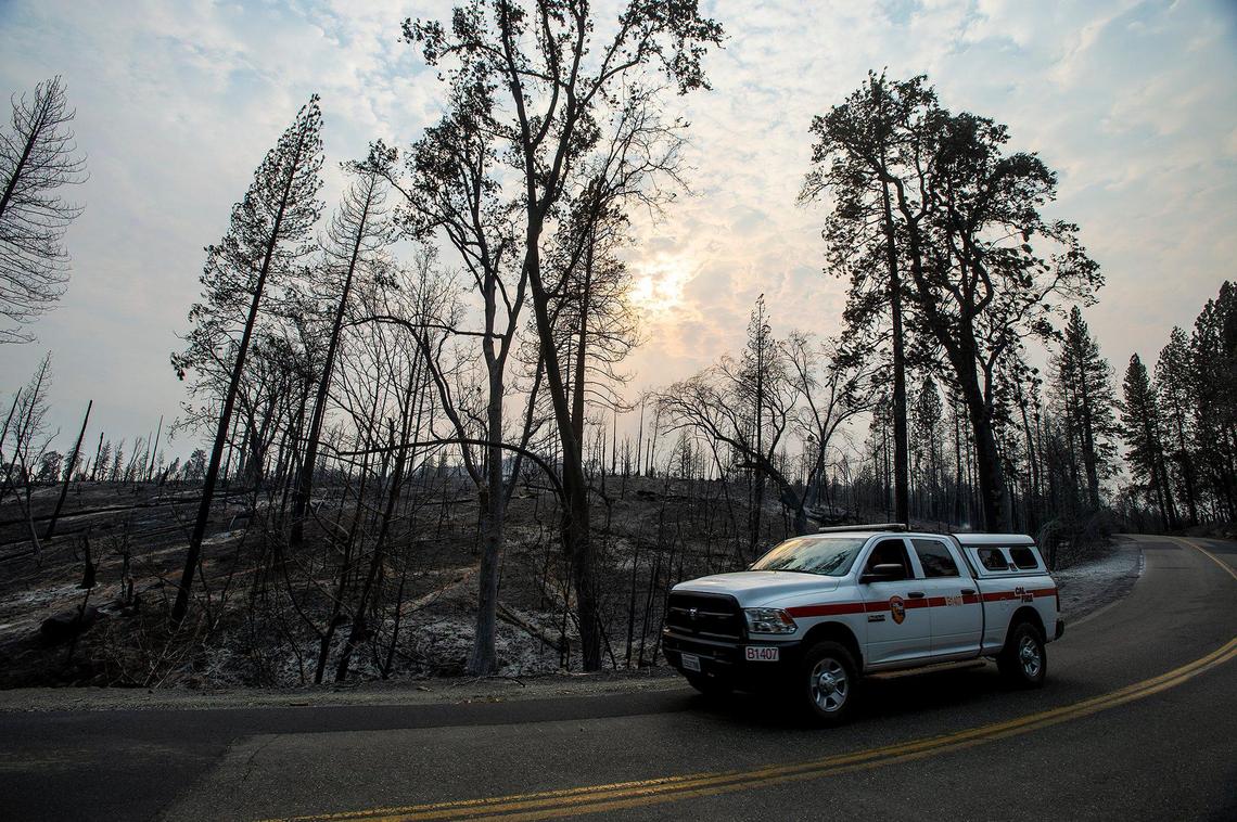 A Cal Fire vehicle drives along Jerseydale Road as firefighters continue to battle the Oak Fire in Mariposa County, Calif., on Tuesday, July 26, 2022.