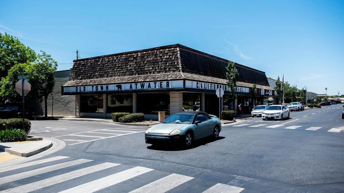 Vehicles drive through the intersection of Broadway Avenue and Fourth Street in downtown Atwater, Calif., on Monday May 24, 2021.