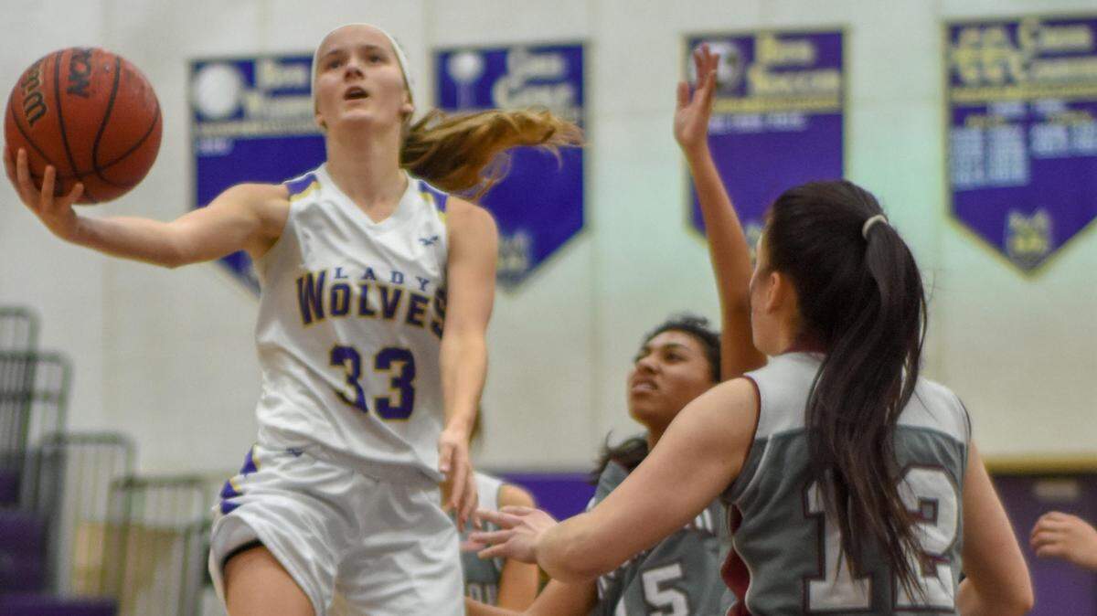Livingston High senior Annie Winton goes up for a basket against Riverbank in a game earlier this season. Winton is second in the state in scoring this season with an average of 27.2 points per game.