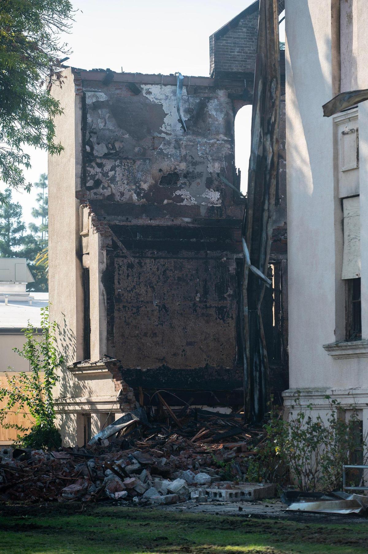 The remains of a historic 19th century building and the first Merced County building constructed as a high school, after a fire damaged the structure located at 2125 M Street in Merced, Calif., on Tuesday, Dec. 3, 2024. Both city and county firefighters responded to the blaze which broke out inside the structure Monday morning.