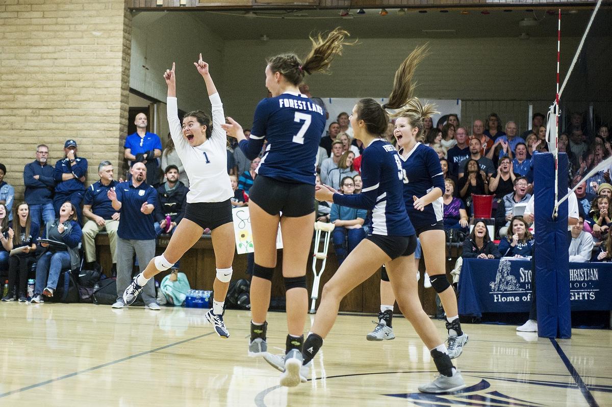 Forest Lake Christian junior  Raegan Tanon (1) jumps in the air as she celebrates a Falcons point with teammates during a match against Stone Ridge Christian in the CIF NorCal Division VI Regional Championship at First Baptists Merced in Merced, Calif., on Tuesday, Nov. 13, 2018. The Knights beat the Falcons 3-0.