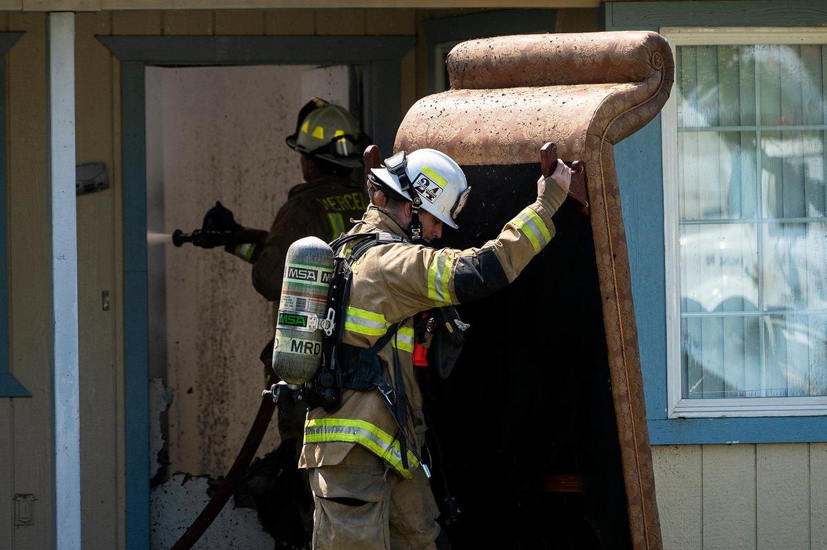 Cal Fire Merced County firefighters and City of Merced firefighters battle a structure fire which damaged two homes in the 1800 block of Dunn Road in Merced County, Calif., on Wednesday, Aug. 23, 2023. Fire officials said the cause of the fire is under investigation.