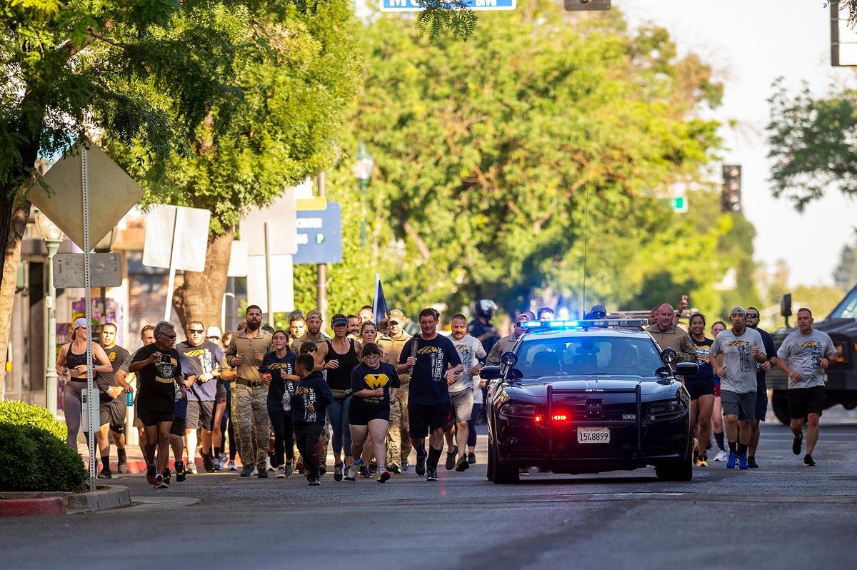 Participants in the Law Enforcement Torch Run for Special Olympics Northern California make their way along West Main Street in Merced, Calif., on Thursday, June 15, 2023.