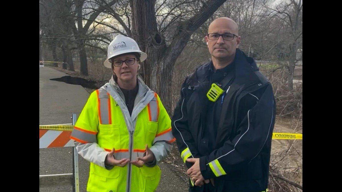 Merced City Manager Stephanie Dietz, left, is shown with Merced Fire Chief Derek Parker, right, during a video on Bear Creek amid massive floods in the city. Photo SCREENSHOT City of Merced Facebook page