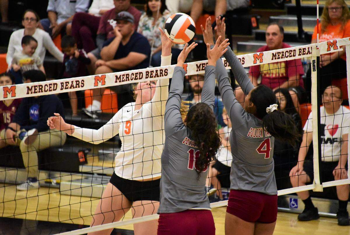 Merced junior Ellia Hamm goes up for the ball at the net against two Golden Valley players during a match on Wednesday, Oct. 23, 2019 at Merced High School.