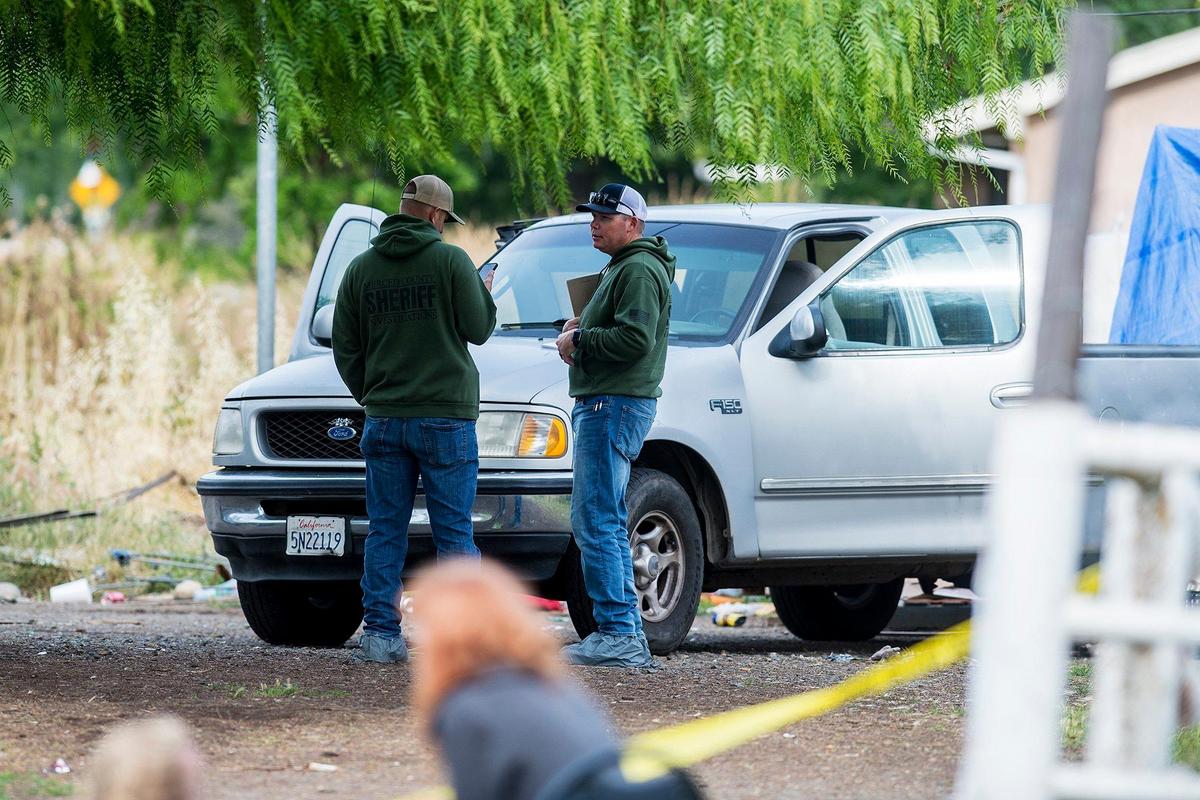The Merced County Sheriff’s Office investigates the death of a man who was found inside a travel trailer behind a residence, near the intersection of Lake Road and Yosemite Avenue in Merced, Calif., on Thursday, May 23, 2019.